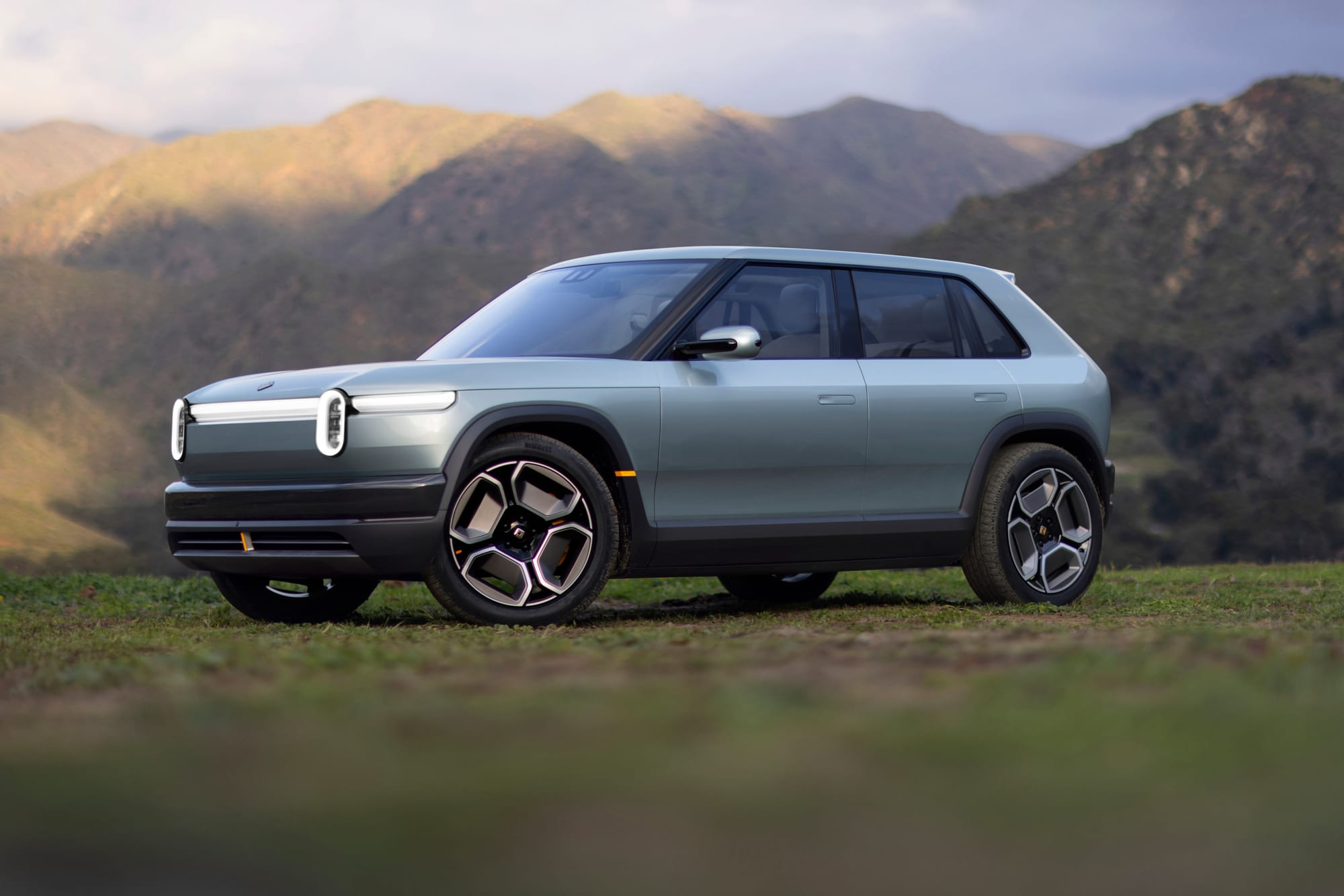 Rivian R3 featured in the mountains.